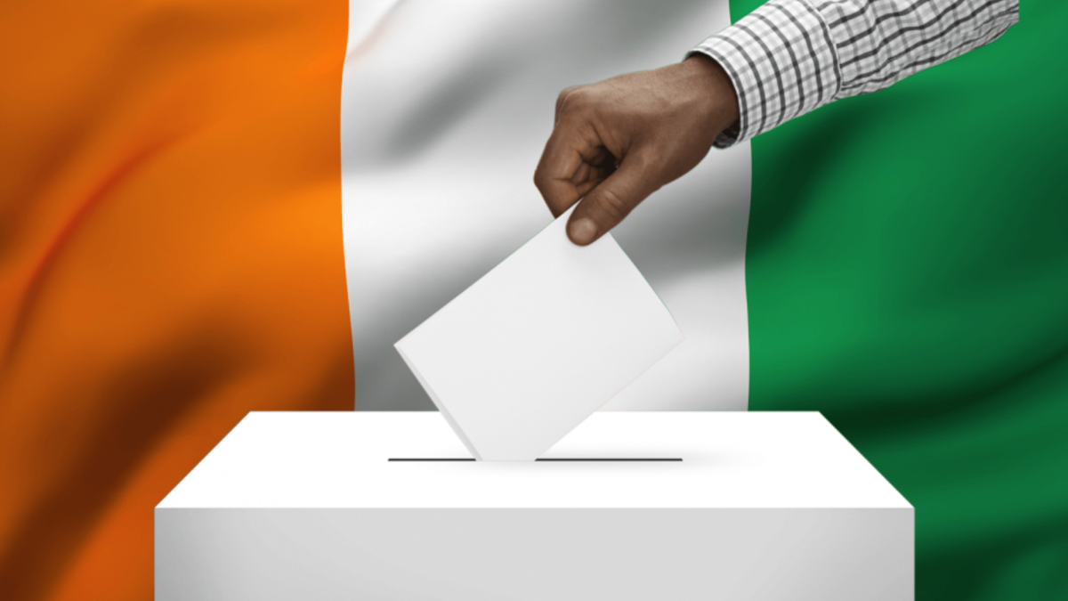 Hand placing a ballot in the ballot box